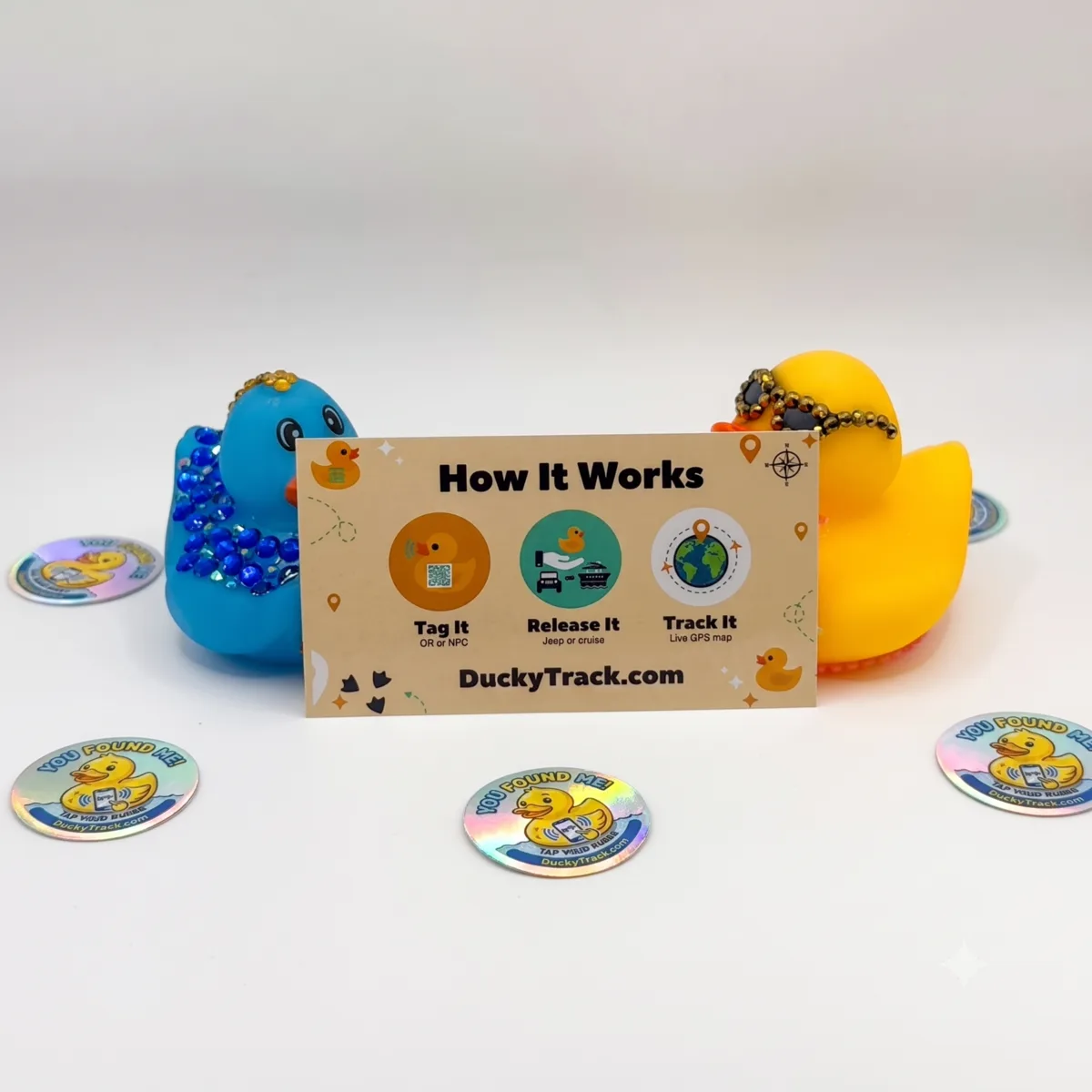 Premium NFC-tagged rubber ducks with holographic You Found Me stickers and quick-start card
